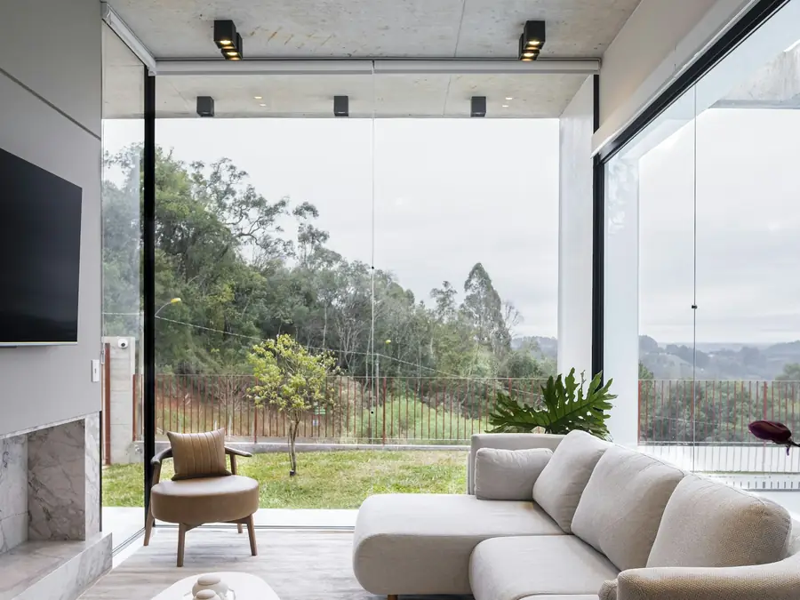 Modern living room with large windows and a long sofa