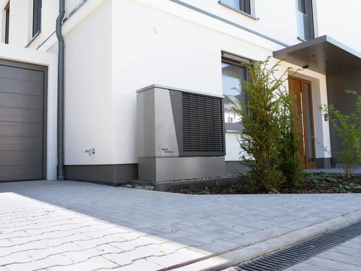Modern home exterior with an outdoor heat pump unit
