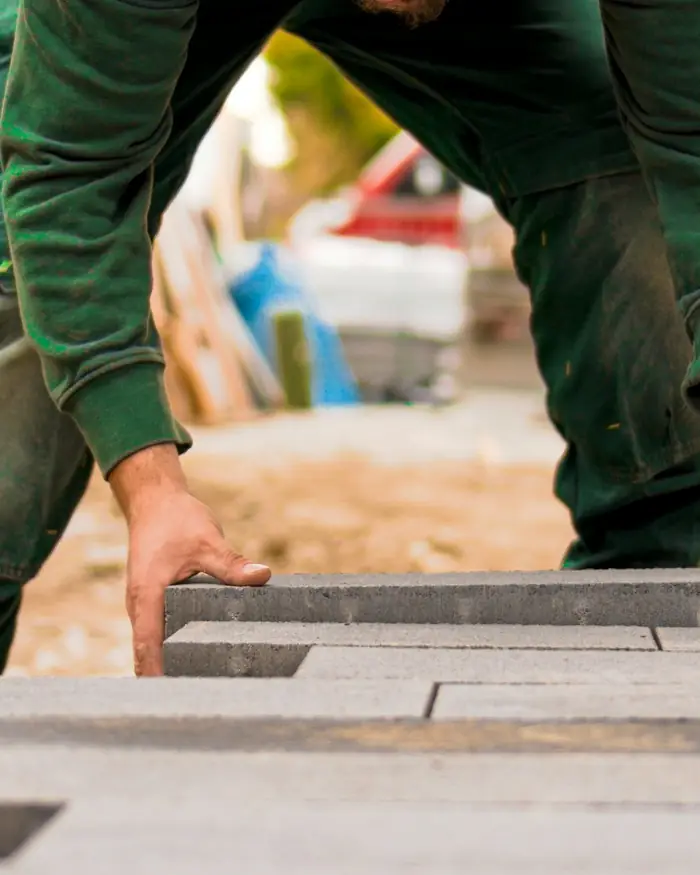 Landscaper laying paving stones for a new patio