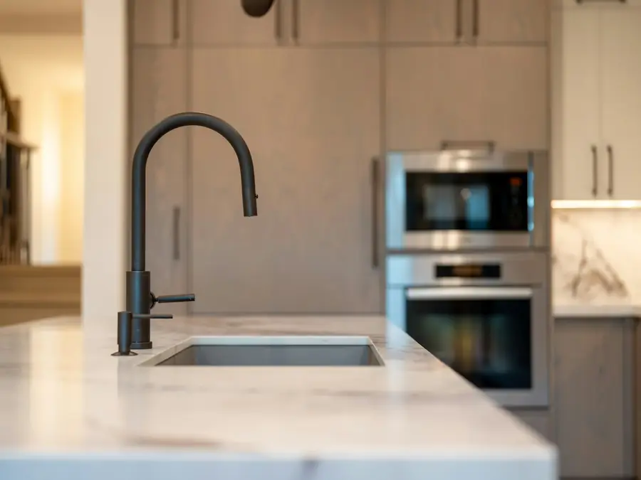 Modern kitchen sink with a black faucet