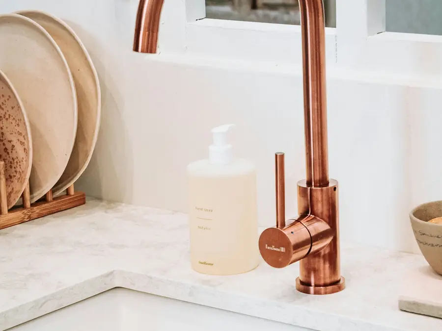 White square sink with a brass faucet