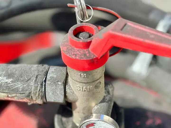 Red shut-off valve with a pressure gauge